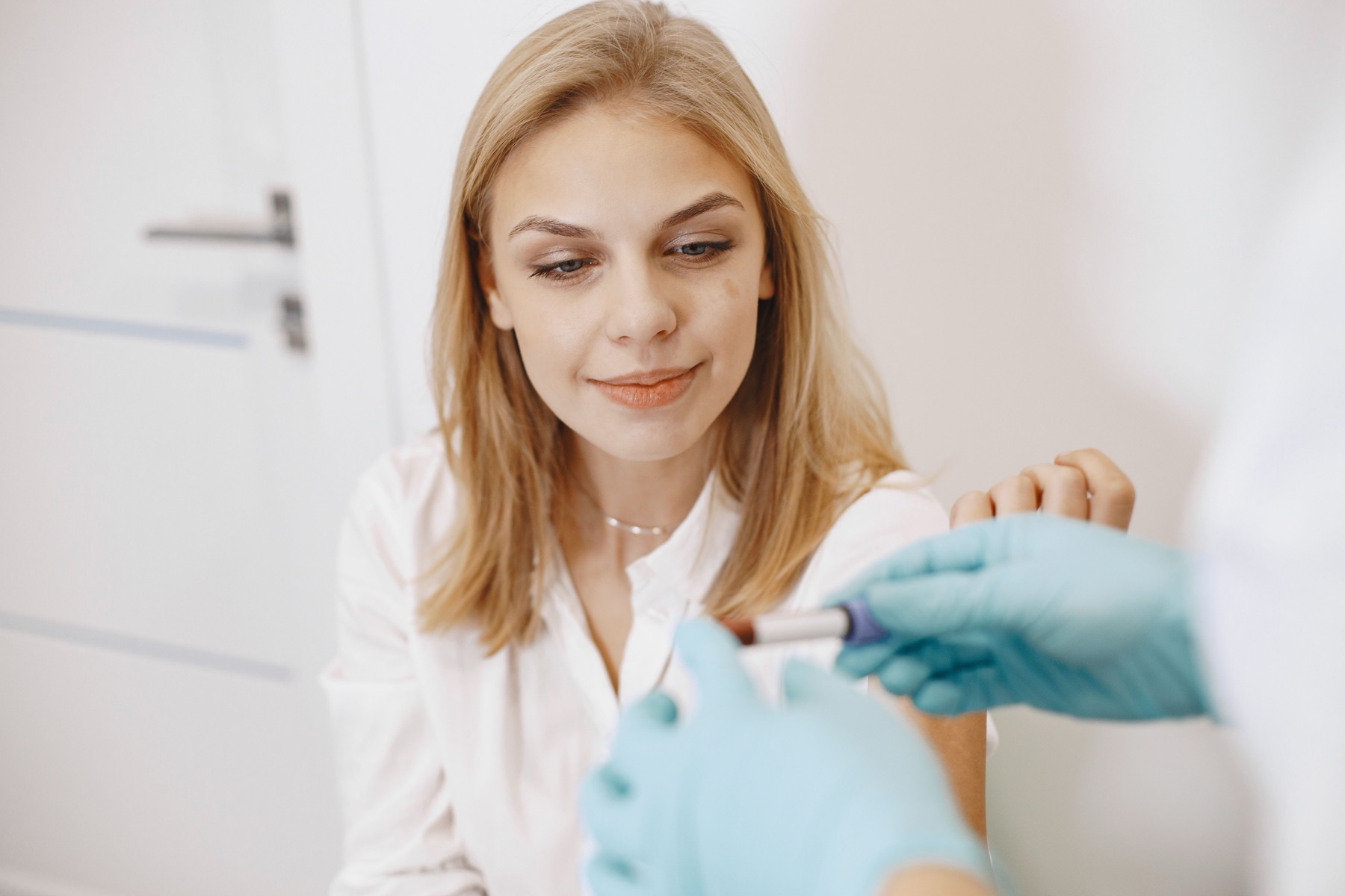 Clinician handling a blood sample during laboratory testing