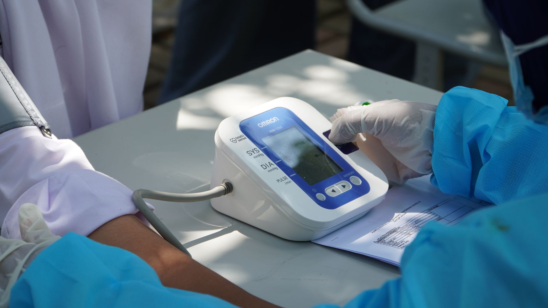 Preventive health professional checking a patient’s blood pressure