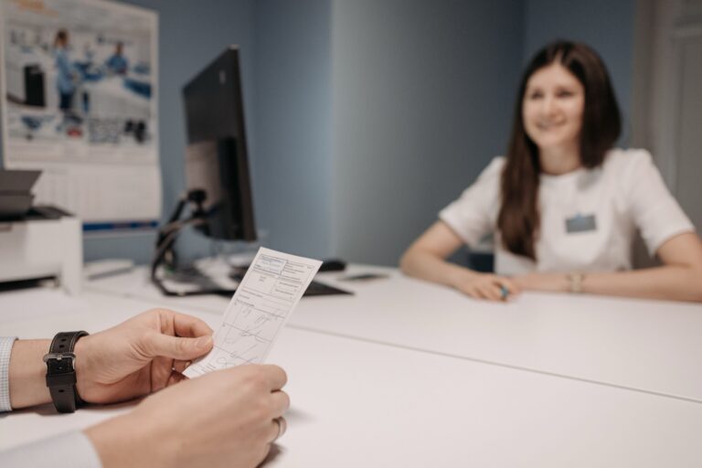 Patient holding a prescription during a medication review in a clinic