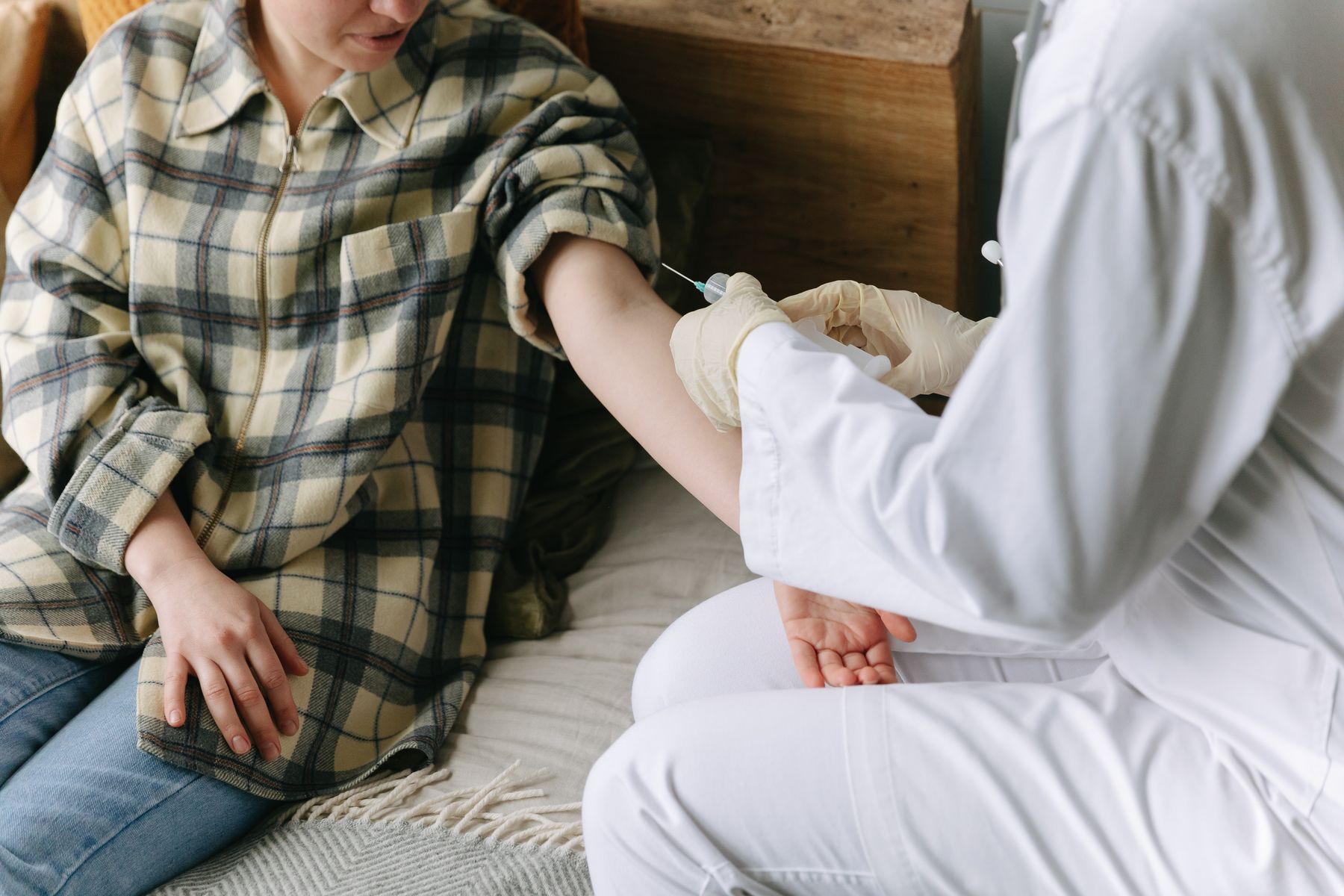 Clinician administering an injection during a medical treatment visit