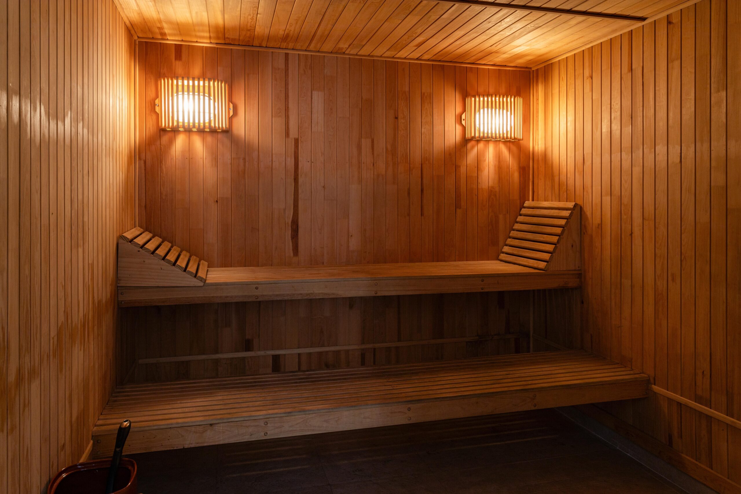 Warm wooden sauna interior with benches and soft lighting
